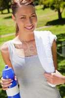 Woman smiling while holding a sports bottle