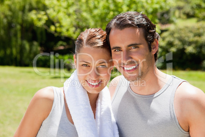 woman with and man smiling in workout gear