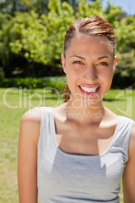 Woman smiling while looking straight ahead