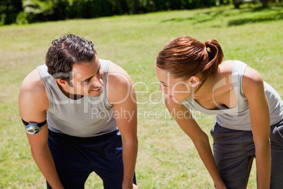 Man and a woman bending over while looking at each other