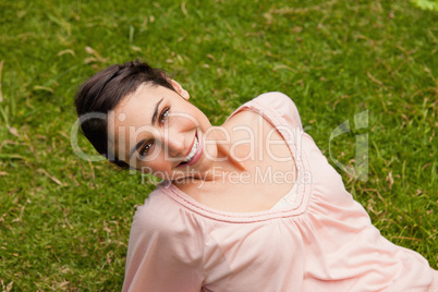 Smiling woman tilting her head while lying down