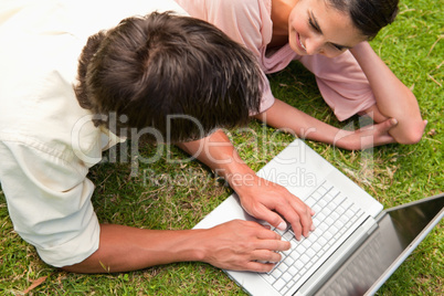 Elevated view of two friends using a laptop together