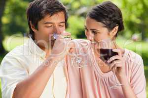 Man drinking wine while his friend looks at him