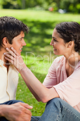 Woman embracing her friends face with her hands