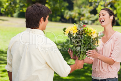 Man presents his friend with flowers