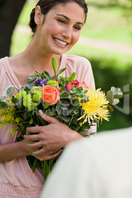 Woman holding flowers which she has been given