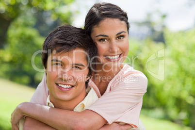 Woman smiling with her friend who is carrying her