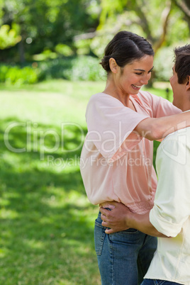 Two friends smiling while holding each other