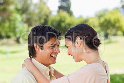 Two friends laughing as they hold each other