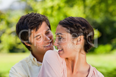 Two friends looking at each other while hugging together