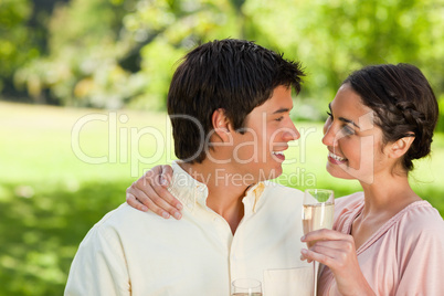 Woman looking at her friend while holding a glass of champagne