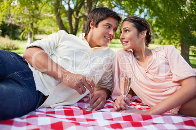 Two friends looking at each other while having a picnic
