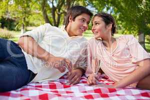 Two friends looking at each other while having a picnic