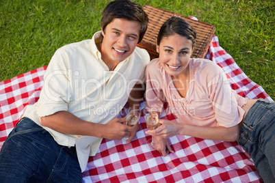 Two friends looking upwards during a picnic