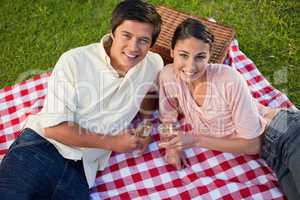 Two friends looking upwards during a picnic