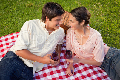 Two friends looking at each other while holding glasses of wine