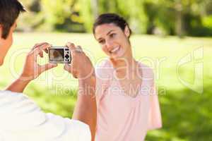 Man takes a photo of his smilng friend