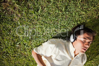 Elevated view of a man using headphones to listen to music while