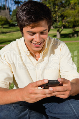 Man using a phone while he is sitting down