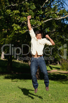 Man jumping with his arms raised as he rejoices