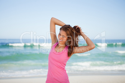 Young woman going to tie up her hair