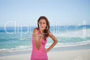 Young woman blowing an air kiss on the beach