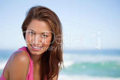 Young woman staring at the camera while sunbathing