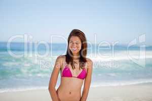 Young woman smiling while wearing swimsuit on the beach