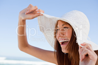 Young attractive woman screaming of joy in front of the sea