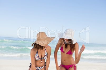 Young attractive women standing upright together in front of the
