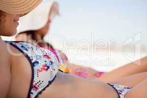 Attractive young woman in bikini lying on the beach