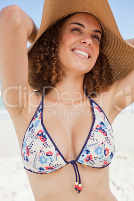 Young smiling woman looking towards the side while standing upri