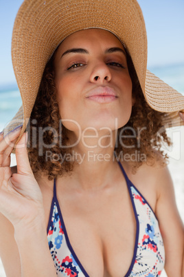Young attractive woman standing upright with puckered lips