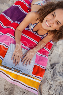 Overhead view of a young attractive woman using her laptop on th