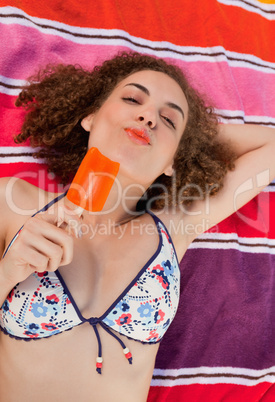 Young woman enjoying her delicious ice lolly