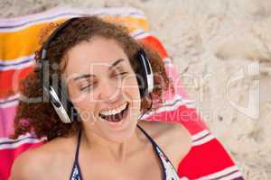Young woman closing her eyes while listening to music