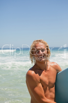 Young blonde man looking at the camera while smiling