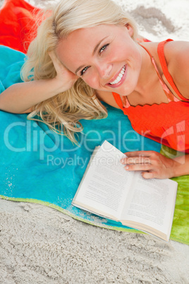 Overhead view of a young woman looking at the camera while lying