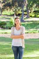 Woman with her arms folded standing in the park