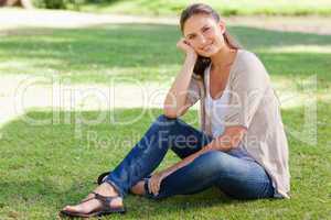Smiling woman sitting on the grass