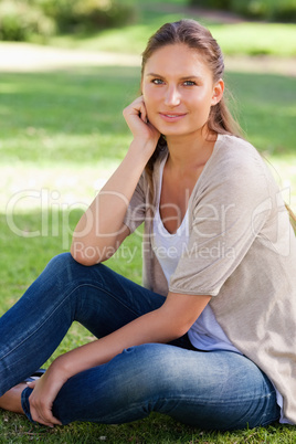 Thoughtful woman sitting on the lawn