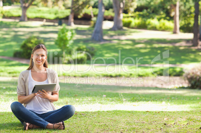 Woman in the park using her tablet computer