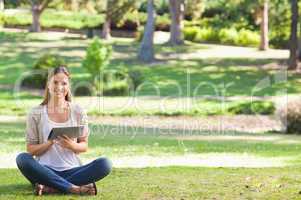 Woman in the park using her tablet computer