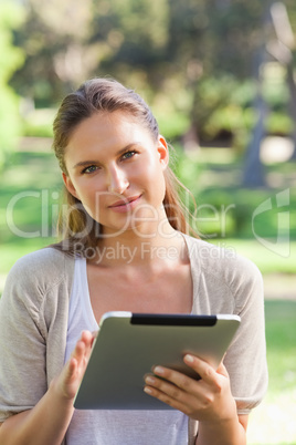 Woman with a tablet computer in the countryside