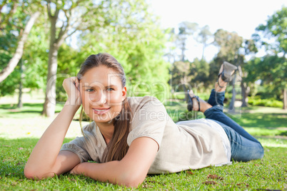 Relaxed woman lying in the park