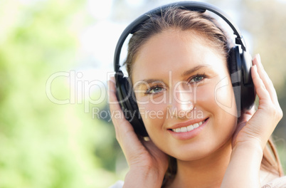 Close up of a woman listening to music in the park