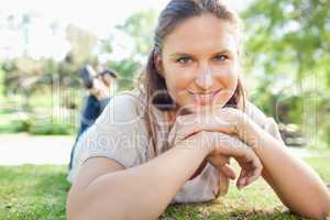 Smiling woman lying on the grass