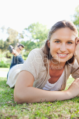 Smiling woman laying on the grass