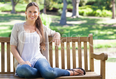 Woman sitting on a bench in the park