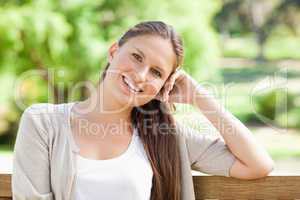 Smiling woman enjoying her day on a bench
